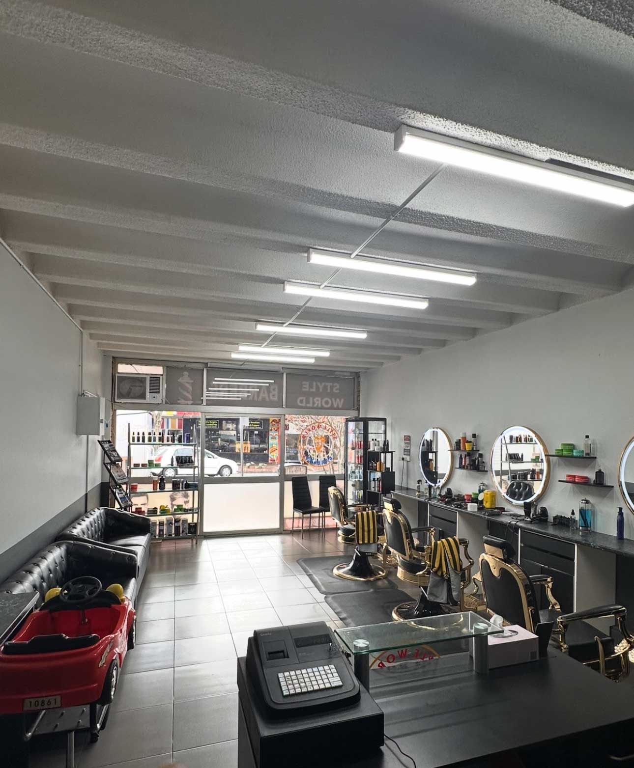 Style World Barbers Engadine shop interior — gold barber chairs and professional barber setup