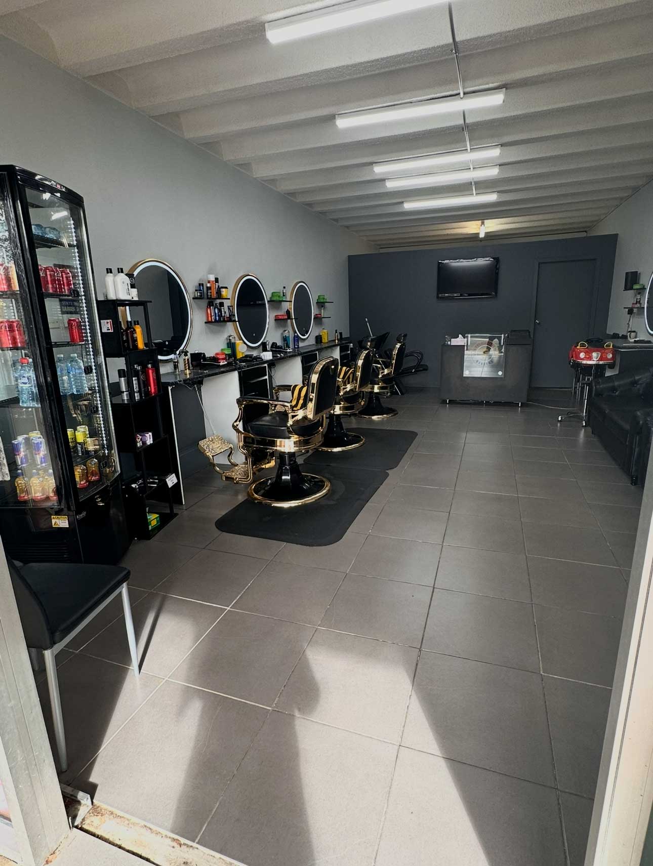 Style World Barbers Engadine — luxury gold barber chairs and premium station setup